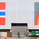 A man cycles past a warehouse in Oslo, Norway.